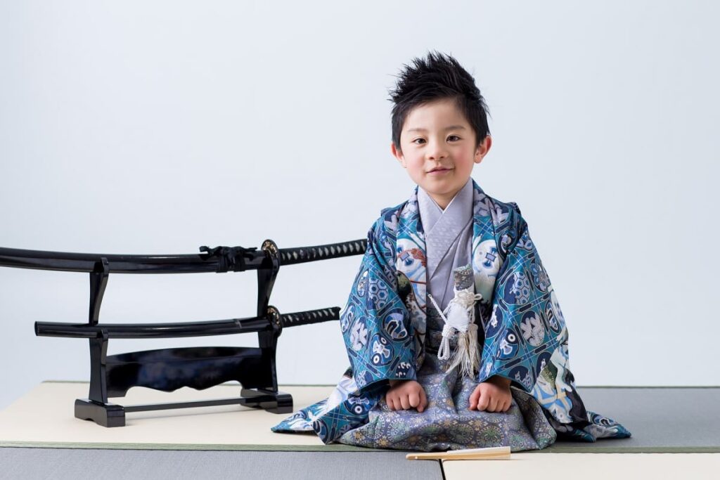 boy sitting in seiza position on tatami mat in a traditional Japanese room