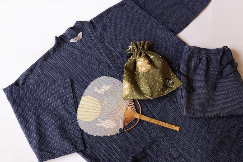 traditional Japanese jinbei summer outfit with uchiwa fan and kinchaku pouch