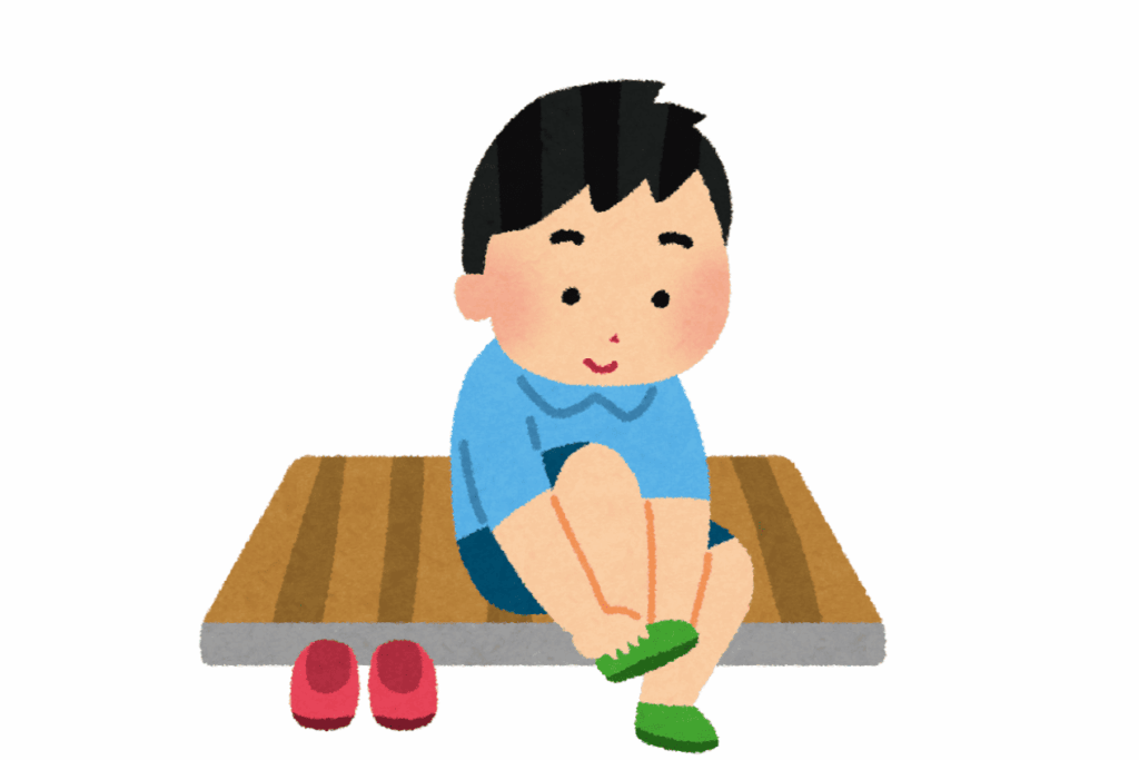 Japanese boy taking off shoes in the house