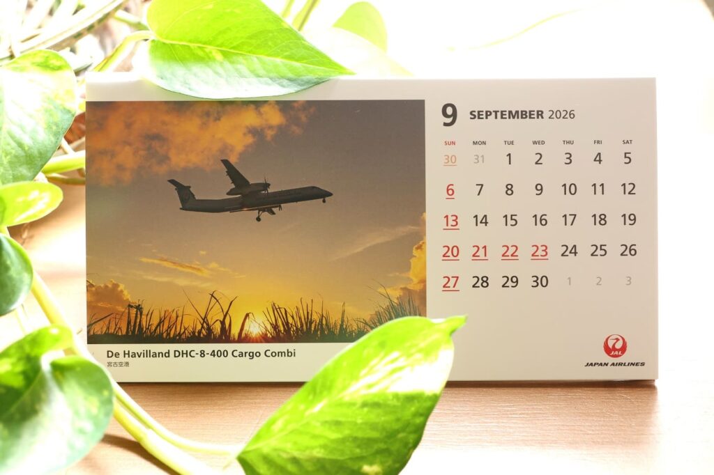 September 2026 desk calendar with September 20 to 23 marked, featuring an airplane photograph